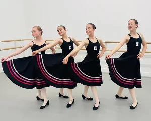 Royal Academy of Dance Exam Success 2025 - 4 young dancers with skirts